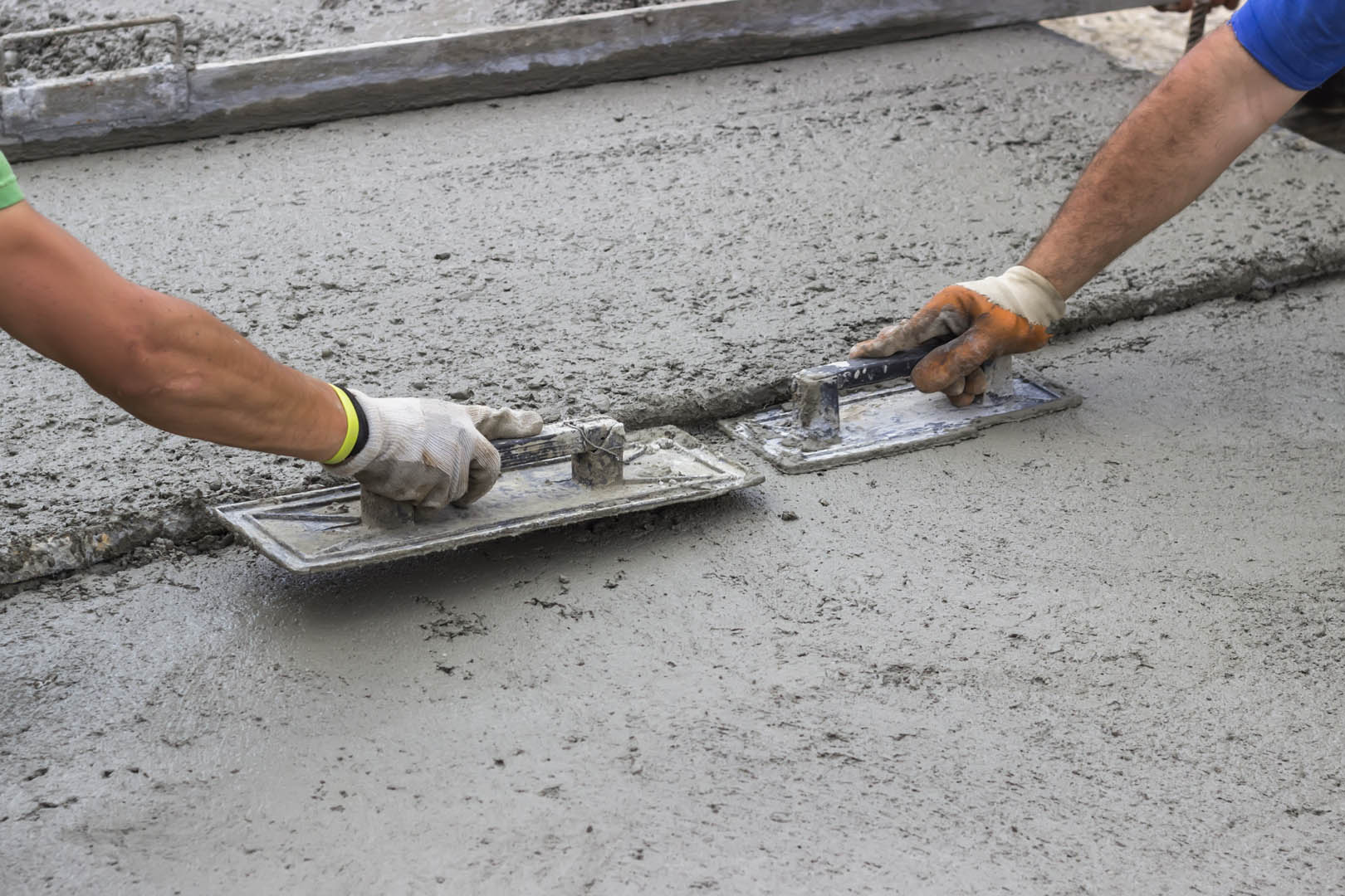 A person is using cement to make concrete.