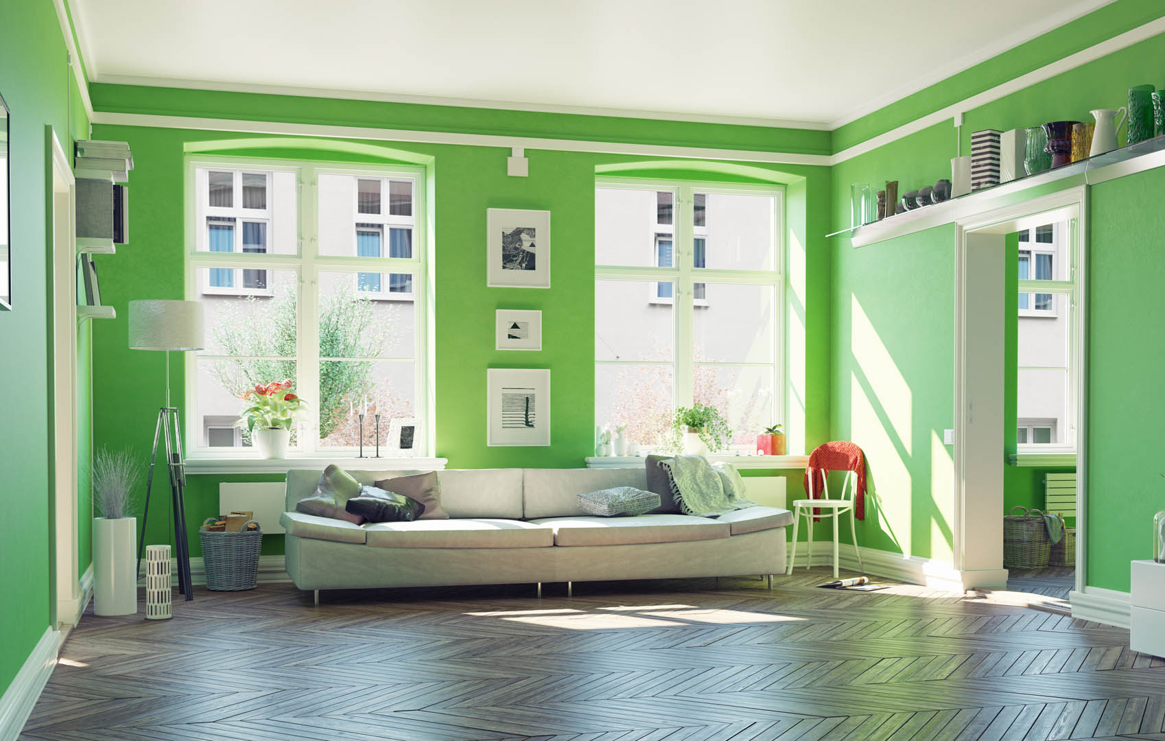 A living room with green walls and white furniture.